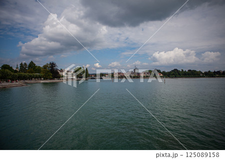 Calm waters of Bodensee reflect clouds on a serene summer day by the lakeside promenade Calm waters of Bodensee reflect clouds on a serene summer day by the lakeside promenade 125089158