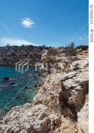 Stunning rocky coastline of Ayia Napa revealing crystal clear waters in Cyprus during a sunny day 125089176