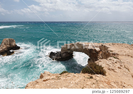 Majestic sea arch at Ayia Napa, Cyprus creating a stunning coastal view with vibrant blue waters 125089297