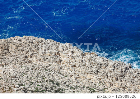 Crystal-clear waves crashing against rocky shores of Ayia Napa reveal natural beauty of Cyprus coastline Crystal-clear waves crashing against rocky shores of Ayia Napa reveal natural beauty of Cyprus coastline 125089326