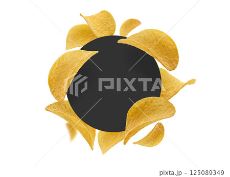 Potato chips on a white background with a black circle in the center Potato chips on a white background with a black circle in the center 125089349