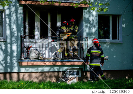 Firefighters are urgently responding to an emergency situation taking place on a balcony 125089369