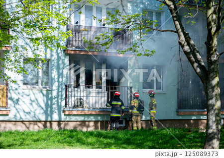Firefighters are bravely battling a major residential blaze in an urban area, showing skill 125089373