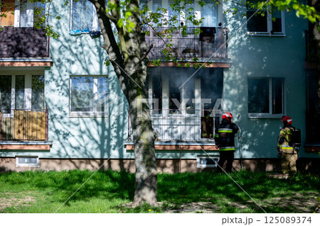 Firefighters are bravely responding to a residential fire incident to protect lives and property Firefighters are bravely responding to a residential fire incident to protect lives and property 125089374