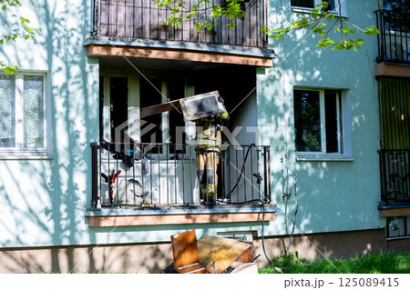 A brave firefighter rescues from a balcony during an emergency, showing courage and commitment A brave firefighter rescues from a balcony during an emergency, showing courage and commitment 125089415
