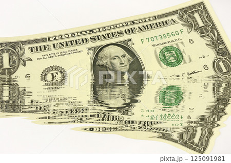 Water Reflection US Dollar Bills. Conceptual Finance Background. Creative conceptual image of US dollar bills partially submerged in water with a water reflection effect. Water Reflection US Dollar Bills. Conceptual Finance Background. Creative conceptual image of US dollar bills partially submerged in water with a water reflection effect. 125091981