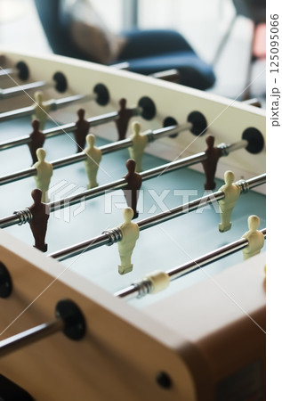 Close-up of foosball table players in brown and cream, indoor light and focus. High quality photo Close-up of foosball table players in brown and cream, indoor light and focus. High quality photo 125095066