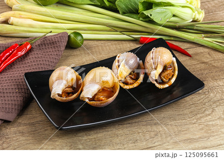 Snails baked with garlic and spices 125095661