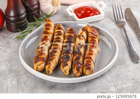 Grilled meat sausages wrapped bacon 125095678