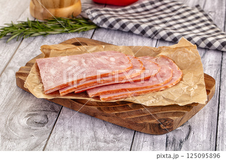 Sliced porjk ham over boatd 125095896