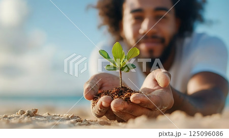 young woman holding soil and plant in hands 125096086