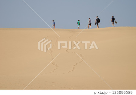 Family walking on a dune. Family walking on a dune. 125096589