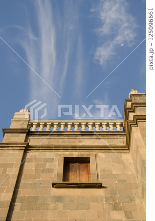 Moon and cloudscape over a building. 125096661