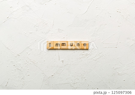Immune word written on wood block. Immune text on cement table for your desing, Top view concept 125097306