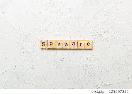 spyware word written on wood block. spyware text on cement table for your desing, concept 125097333