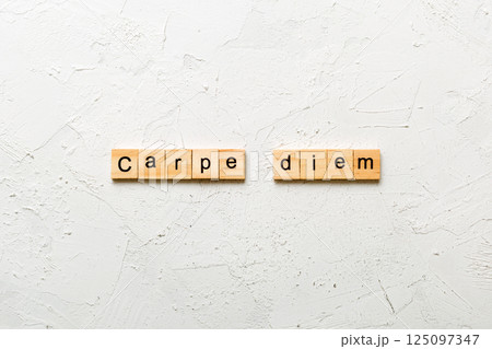 Carpe diem word written on wood block. Carpe diem text on table, concept Carpe diem word written on wood block. Carpe diem text on table, concept 125097347