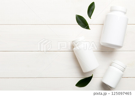 supplement pills with medicine bottle health care and medical top view. Vitamin tablets. Top view mockup bottle for pills and vitamins with green leaves, natural organic bio supplement, copy space supplement pills with medicine bottle health care and medical top view. Vitamin tablets. Top view mockup bottle for pills and vitamins with green leaves, natural organic bio supplement, copy space 125097465