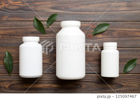 supplement pills with medicine bottle health care and medical top view. Vitamin tablets. Top view mockup bottle for pills and vitamins with green leaves, natural organic bio supplement, copy space supplement pills with medicine bottle health care and medical top view. Vitamin tablets. Top view mockup bottle for pills and vitamins with green leaves, natural organic bio supplement, copy space 125097467