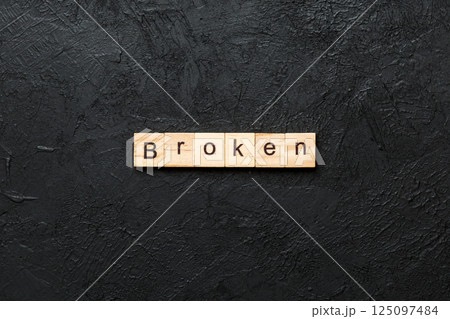 BROKEN word written on wood block. BROKEN text on cement table for your desing, concept BROKEN word written on wood block. BROKEN text on cement table for your desing, concept 125097484