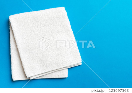 Top view of white towels with copy space on colored background Top view of white towels with copy space on colored background 125097568
