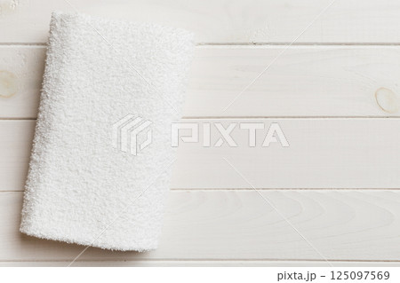 Top view of white towels with copy space on colored background Top view of white towels with copy space on colored background 125097569