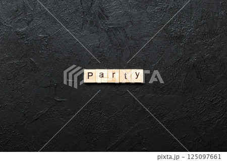 PARTY word written on wood block. PARTY text on cement table for your desing, concept 125097661