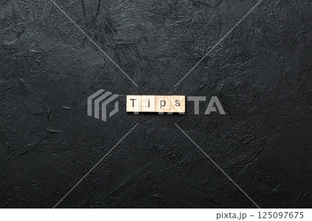 tips word written on wood block. tips text on table, concept tips word written on wood block. tips text on table, concept 125097675