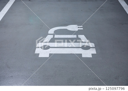 Electric car charging station in a carpark 125097796