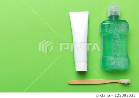 Mouthwash and other oral hygiene products on colored table top view with copy space. Flat lay. Dental hygiene. Oral care products and space for text on light background. concept 125098033