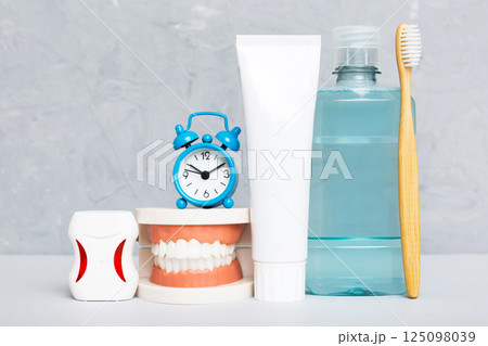 Mouthwash and other oral hygiene products on colored table top view with copy space. Flat lay. Dental hygiene. Oral care kit. Dentist concept 125098039