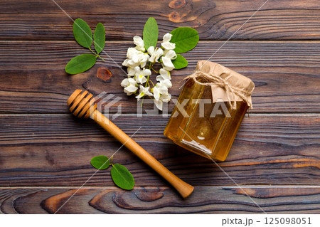 honey jar with acacia flowers and leaves. fresh honey top view flat lay 125098051