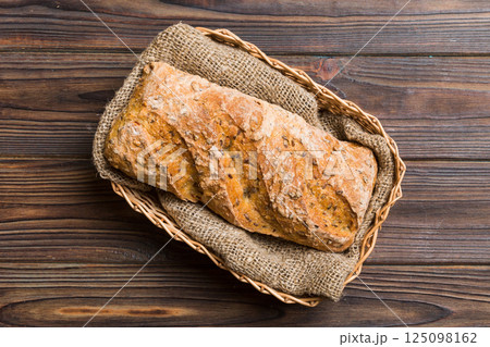 Freshly baked bread on basket against natural background. top view bread copy space Freshly baked bread on basket against natural background. top view bread copy space 125098162