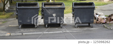 household garbage scattered near the trash garbage can 125098262