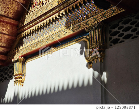 Vintage Golden Thai Traditional Sculpture in front of Buddhist Church. Vintage Golden Thai Traditional Sculpture in front of Buddhist Church. 125098871