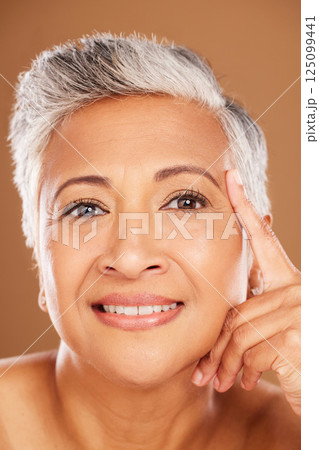 Face, beauty and skincare with a senior woman in studio on a brown background for wellness or natural care. Facial, portrait and cosmetics with a mature female to promote a product for perfect skin Face, beauty and skincare with a senior woman in studio on a brown background for wellness or natural care. Facial, portrait and cosmetics with a mature female to promote a product for perfect skin 125099441