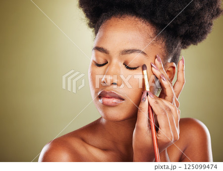 Eyeshadow, black woman and makeup brush for beauty, eyeliner product application or cosmetology cosmetics on studio background. African model, makeup artist and eyelid powder for elegant natural face 125099474