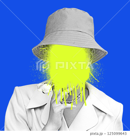 Composite artwork. Person in hat holding flower against blue background, yellow paint on face showing silence and lost self. 125099643