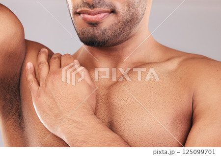 Beard, armpit and body skincare of man in studio isolated on a gray background. Hygiene, grooming and chest hair removal of muscular male fitness model, waxing and cleaning for wellness and beauty. 125099701