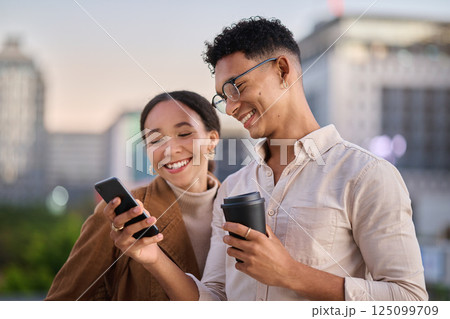 City, social media and young couple with phone looking at meme, online content and browsing internet. Technology, relationship and man standing with woman in urban town on smartphone together 125099709