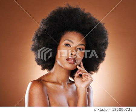 Skincare, natural hair and black woman beauty portrait in studio with skin glow, wellness and healthy glow for cosmetics or makeup marketing. African girl model face, hair care growth and skin care Skincare, natural hair and black woman beauty portrait in studio with skin glow, wellness and healthy glow for cosmetics or makeup marketing. African girl model face, hair care growth and skin care 125099725