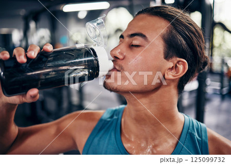 Drinking water, fitness and gym man with challenge workout training for muscle, power and energy with motivation, goals and sweating. Tired sports, athlete person with water bottle in health exercise 125099732