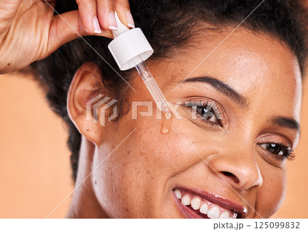 Black woman, face serum or dropper in skincare oil routine, healthcare grooming or wellness in retinol dermatology, collagen or vitamin c. Zoom, smile or happy beauty model with facial liquid product Black woman, face serum or dropper in skincare oil routine, healthcare grooming or wellness in retinol dermatology, collagen or vitamin c. Zoom, smile or happy beauty model with facial liquid product 125099832