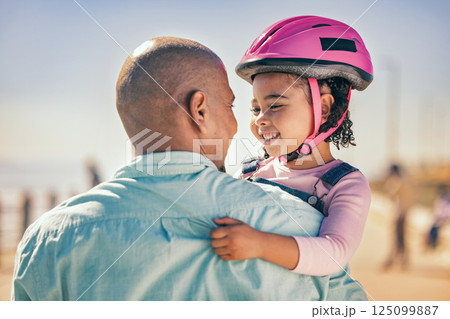 Family, love and girl with dad and helmet for safety before cycling together at park outdoors, happy and hug. Children, learning and father embrace daughter, bonding and talking before riding a bike Family, love and girl with dad and helmet for safety before cycling together at park outdoors, happy and hug. Children, learning and father embrace daughter, bonding and talking before riding a bike 125099887