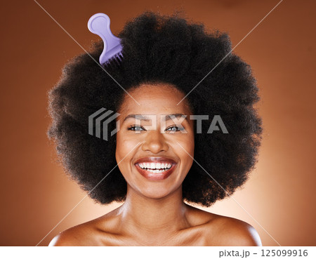 Black woman. hair care and comb in afro, happy face and skincare with smile, beauty or glow in brown studio background. Cosmetic and skin health of wellness model, happiness or content face with joy Black woman. hair care and comb in afro, happy face and skincare with smile, beauty or glow in brown studio background. Cosmetic and skin health of wellness model, happiness or content face with joy 125099916