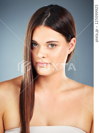 Woman, beauty and hair in skincare or salon for cosmetics, makeup or treatment against a studio background. Portrait of beautiful female model with smile in satisfaction for haircare or skin wellness 125099925