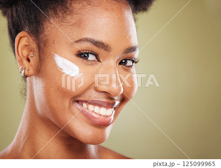 Black woman, face or skincare cream product on green studio background in healthcare wellness, dermatology or cosmetology. Zoom, smile portrait or happy beauty model with sunscreen or facial collagen Black woman, face or skincare cream product on green studio background in healthcare wellness, dermatology or cosmetology. Zoom, smile portrait or happy beauty model with sunscreen or facial collagen 125099965