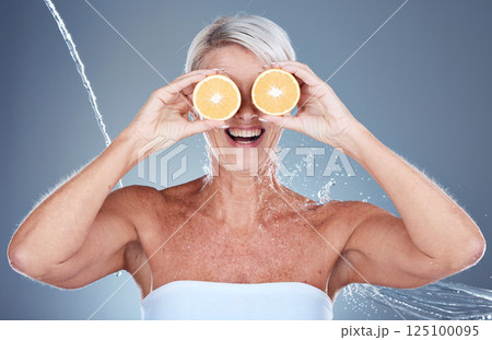 Woman, water splash and lemon fruit skincare grooming for vitamin c treatment, facial blemish or dermatology cosmetology. Smile, happy or mature beauty model with citrus food or product covering eyes 125100095