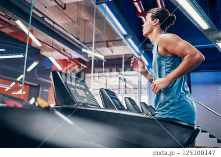 Fitness, man and running on treadmill for workout, exercise or cardio training for endurance at the gym. Active male runner in sports wellness having a run on stationary equipment at the health club 125100147