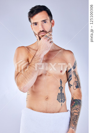 Man, thinking and tattoo with a towel, shower and sexy against grey studio background with mockup space. Portrait, idea and male model with creative body ink, art and after a bath, clean or beauty Man, thinking and tattoo with a towel, shower and sexy against grey studio background with mockup space. Portrait, idea and male model with creative body ink, art and after a bath, clean or beauty 125100306