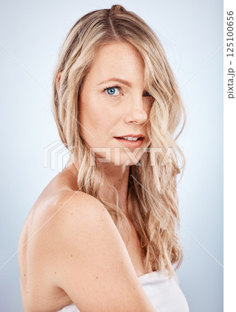 Portrait, cosmetics and young woman with skincare, hair and natural beauty with grey studio background. Confident, makeup and healthy girl with organic facial, wellness and smooth skin for body care 125100656